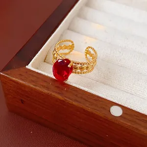 Vintage gold adjustable ring with large oval red zircon in a luxury jewelry box