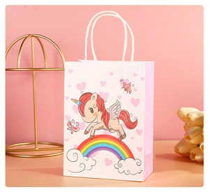 Pink gift bag detail with cute cartoon unicorn rainbow pattern and white cord handles