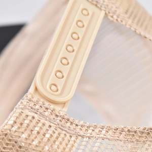 Close-up of the adjustable snapback strap and breathable mesh of the trucker hat