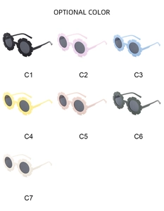 Selection of seven colorful sunflower-shaped sunglasses for kids in various soft pastel tones