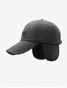 Detail of grey winter baseball cap with ear flaps and titanium side embroidery