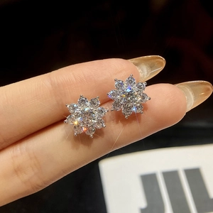 Micro shot of flower-shaped stud earrings in silver finish with pavé moissanite stones
