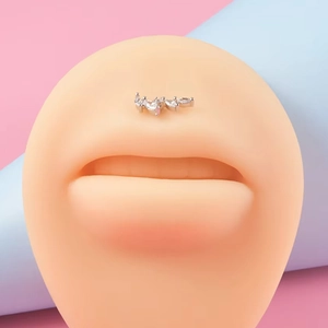 Titanium silver labret stud with zircon row inlay on a realistic lip model