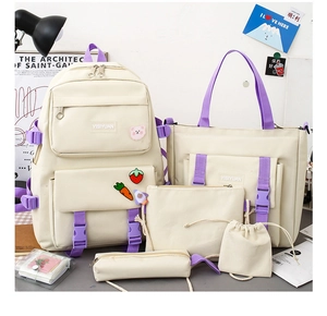Close-up of the 5-piece beige and purple canvas school bag set with cute cartoon pins