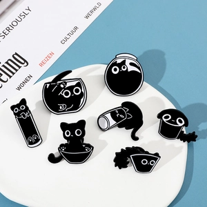 Close-up of 7 cute black cat enamel pins showing funny melting liquid poses in a white bowl
