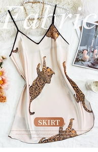 Detail view of leopard print satin sleepwear dress with elegant black trim and accessories