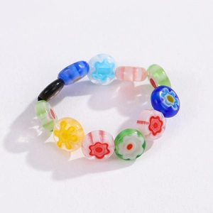 Detail of bohemian millefiori glass flower beaded ring with colorful floral patterns