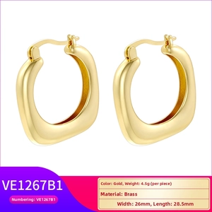 Detail view of irregular gold brass earrings with size 26x28.5mm and 4.5g weight