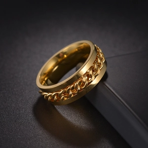 Macro shot of gold-plated spinning chain ring for men featuring polished titanium steel