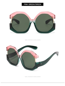 Detail of oversized cat-eye sunglasses featuring pink and green color-block frames