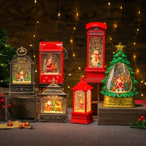 Luminous Christmas water globe lanterns with music and santa figurines on wood
