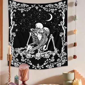 Bohemian black and white skull kiss tapestry with rose vine border on a room wall
