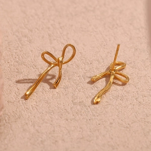 Detailed close-up showing the 18K gold plated bow stud earrings from multiple angles