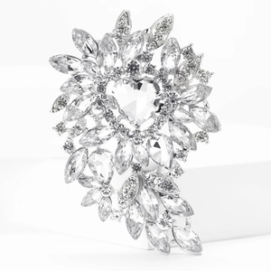Macro shot of silver alloy brooch featuring a large heart-shaped crystal and marquise stones