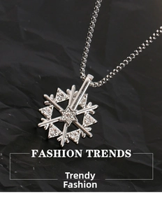 Macro shot of rotatable snowflake pendant with cubic zirconia on a beaded chain