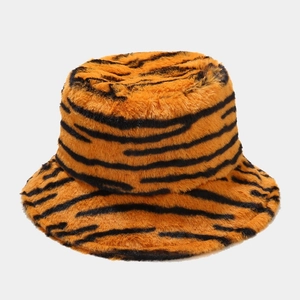 Macro detail of plush faux fur texture on a thick tiger stripe winter bucket hat