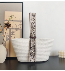Detail of cotton rope tote with paisley pattern strap and decorative wood ring connector