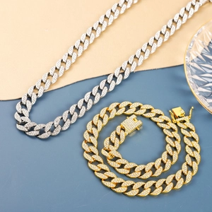 Detailed view of silver and gold Cuban link chains with full sparkling zircon inlay