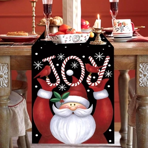 Christmas table runner with Santa Claus holding JOY sign on a festive wooden table
