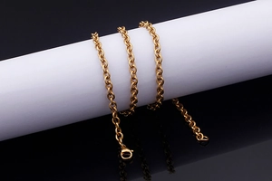 Detail shot of a gold-plated titanium steel necklace with a secure lobster clasp closure