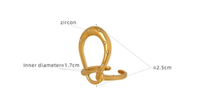 Macro view of gold-plated geometric U-shaped ear cuff featuring inlaid cubic zircon stones