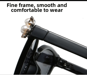 Detailed side view of black vintage sunglasses with elegant pearl accents on the hinge