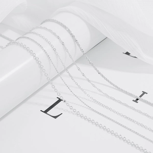 Macro shot of silver S925 plated minimalist chains including water wave and O-link styles