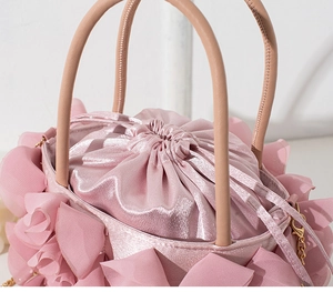 Detailed close-up of pink floral evening bag with chiffon petals and satin interior
