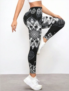 Macro detail of high-waist yoga pants featuring white mandala print on black fabric