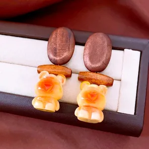 Vintage wooden bear earrings with dark brown accents and amber resin pendants