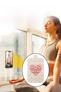 Close-up of double-sided silicone heart suction cup phone holder in cream and pink