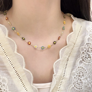 Charming titanium steel necklace featuring colorful daisy pendants on a gold chain
