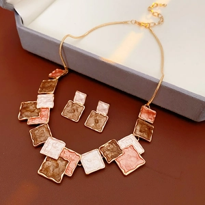 Detail of square enamel jewelry set with necklace and earrings on premium box