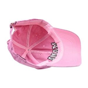 Detail of pink washed cotton baseball cap showing inner stitching and adjustable buckle