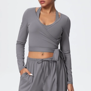 Detail of grey V-neck cross-strap yoga long sleeve top with textured brushed fabric