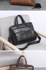 Detail view of vintage business briefcase showing metal D-rings and sturdy leather handles