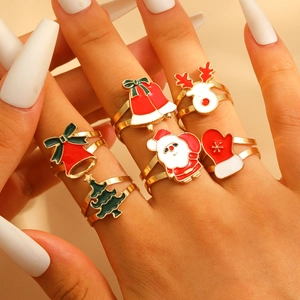 Close-up of 6-piece Christmas ring set with reindeer and tree motifs on a model's hand