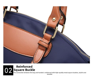 Detail of golden square buckle and brown leather handle on navy blue nylon handbag