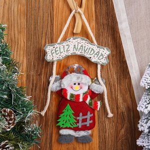 Christmas snowman ornament with Feliz Navidad sign hanging on rustic wooden background