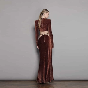 Elegant deep brown velvet backless maxi dress featuring gold chain detail and pleats