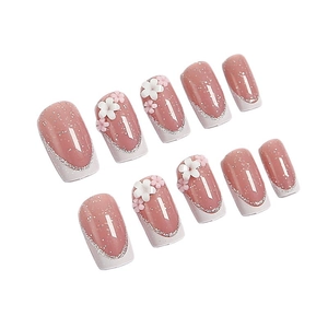White French manicure press-on nails with 3D floral accents and silver glitter finish