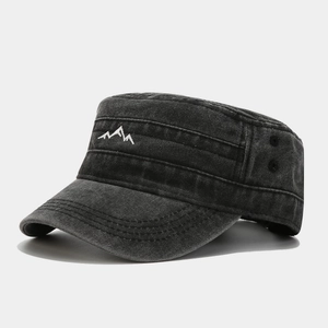 Close-up of white mountain embroidery on washed dark grey denim flat top military cap