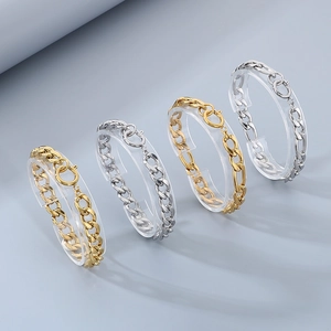 Detail of gold and silver Cuban link bracelets with large round spring clasps
