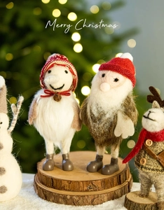 Detail of Christmas felt reindeer and santa figurines with bells on wood base
