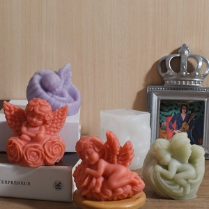 DIY angel wing silicone mold with various finished pastel-colored aromatic wax candles