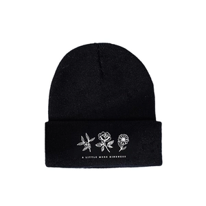 Warm black knitted beanie with flower patterns and A Little More Kindness slogan