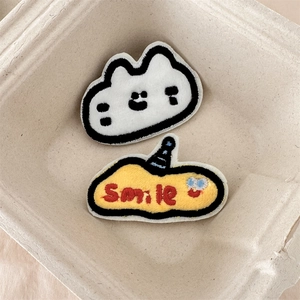Macro detail of Smile embroidery patches with fine stitching on a soft background