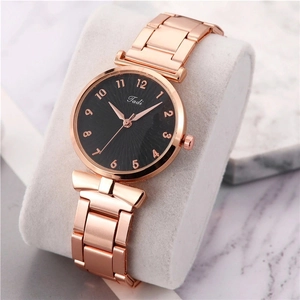Macro detail of Tadi women's quartz watch with rose gold strap and black sunray dial