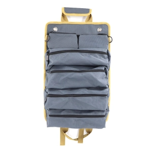Flat lay of gray roll-up tool bag with yellow trim showing multiple zipper pockets