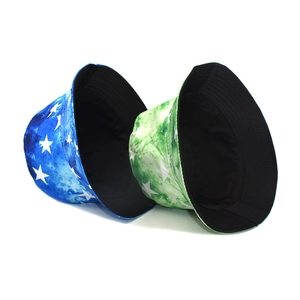Detail of star-patterned tie-dye bucket hats in blue and green with black cotton lining